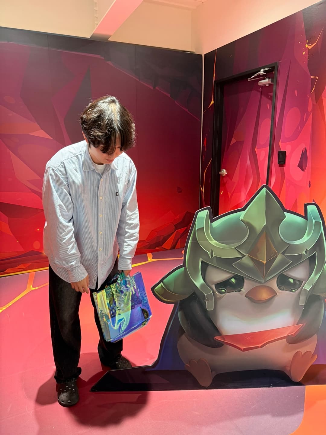 Next to a crying Pengu cutout at the Seoul pop-up